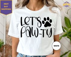 a woman wearing a white t - shirt with the words let's pawty printed on it