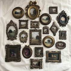 an assortment of framed pictures on a white sheet