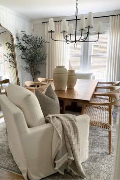 a living room filled with furniture and a large mirror