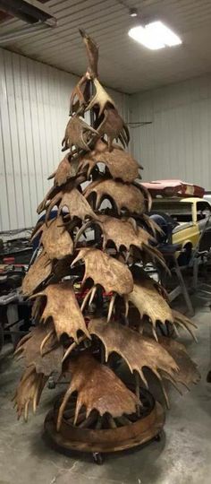 a christmas tree made out of antlers in a garage