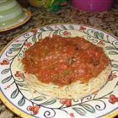 a plate with spaghetti and sauce on it