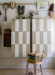 there is a chair in front of a wall with many things on it and two stuffed animals