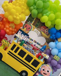 there is a school bus and balloons on the table for children to play in it