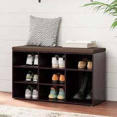 a wooden shoe rack with several pairs of shoes on it