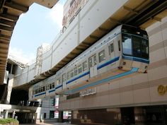 the train is going down the tracks in front of an empty building with no people on it