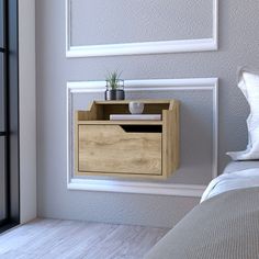 a bed room with a neatly made bed and a wooden cabinet on the wall next to it