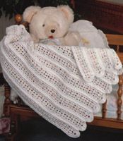 a white teddy bear sitting on top of a wooden chair