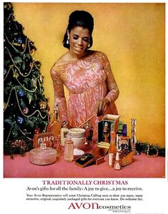 a woman in pink dress standing next to a christmas tree with cosmetics and makeup products on it