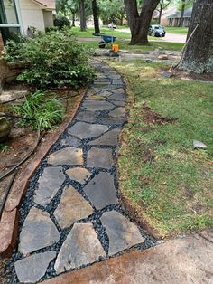 a stone path in front of a house