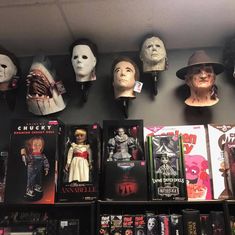 the shelves are filled with halloween movies and masks on display in a store or bookstore