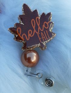 "*2 inch Premium Acrylic, the leaf alone is 2inches. *The Hello Fall leaf has a holographic brown vinyl on top of mix gold glitter.   \"Hello Fall is an orange vinyl.  *Uv Resin has been used to seal glitter and vinyl. *Attached Bead shown in picture is included. *Clear Alligator Clip-Retractable Badge Reel. Care Instructions: -Avoid prolonged contact with extreme heat.  -Clean with a soft cloth. -Acrylic & Uv Resin can break if knocked or dropped on hard surfaces. -Handmade, so please be sure t Circle Badge Reel Ideas, Hocus Pocus Party, Orange Vinyl, Epoxy Crafts, Scrubs Outfit, Medical Jewelry