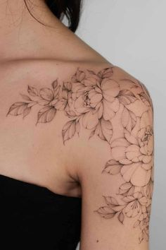 a woman's shoulder with flowers on it