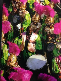 a group of people with colorful costumes and drums