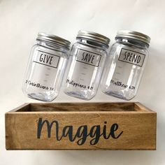 three mason jars sitting on top of a wooden box with the word give in it