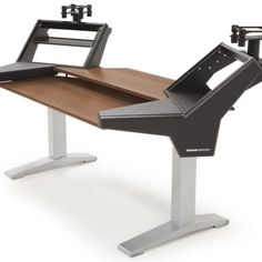 a computer desk with two monitors on it's sides and a keyboard attached to the back