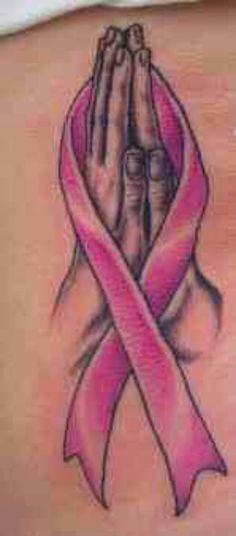 a woman's arm with a pink ribbon and hands in the shape of a heart