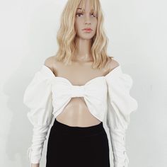 Elevate Your Style With The Seraphim Lace-Up Bow Top From Sustainable Fashion Brand Nathalia Jmag.&Nbsp; The Linen Top Features A Front Bow Bralette And Puffed Sleeves. The Meticulous Details Truly Set This Piece Apart, Adorned With Lace-Up Sleeve Cuffs And An Adjustable Corset Style Lace-Up Back With Oversized Grommets. Yet, Beyond Its Aesthetic Splendor Lies A Deeper Commitment. Crafted From Deadstock Fabric And Tailored To Order Or Sewn In Small Batches, Each Nathalia Jmag Creation Embraces Sustainability Without Compromise. Because True Style Isn't Just About Making A Statementit's About Making A Difference, One Impeccably Crafted Garment At A Time. ****Note- The Xs And Small Are Br White Off-shoulder Crop Top For Parties, White Off-shoulder Crop Top For Night Out, White Evening Crop Top, White Puff Sleeve Crop Top For Party, White Fitted Off-shoulder Blouse, Fitted Off-shoulder White Blouse, White Long Sleeve Crop Top For Party, White Off-shoulder Top For Evening, White Off-shoulder Party Blouse