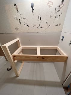 a wooden bench sitting in the middle of a room