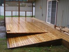 a large wooden deck in front of a house