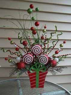 a vase filled with candy canes on top of a table next to a building