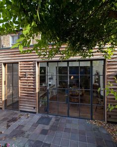 a wooden building with glass doors on the outside