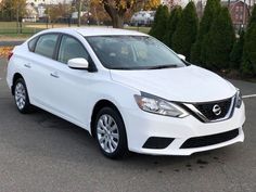 a white car parked in a parking lot