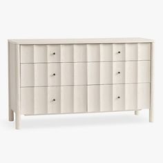 a white dresser with six drawers and two handles on each drawer, against a white background