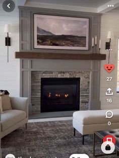 a living room with a fire place and pictures on the fireplace mantel above it