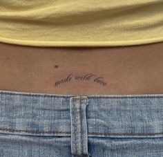 a woman's lower back tattoo with the words made with love written on it