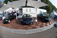 two cars are parked under an awning