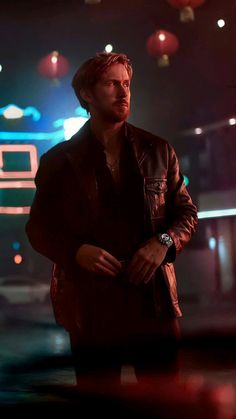 a man standing in the middle of a dark room with red and blue lights behind him