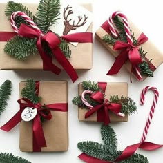 christmas presents wrapped in brown paper and tied with red ribbon are surrounded by candy canes