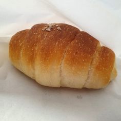 a piece of bread sitting on top of white paper