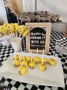 there are many smiley face candies on the table with candy sticks in front of them