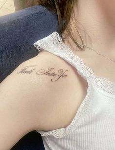 a woman with a small tattoo on her shoulder that says, i love my wife