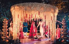 a man and woman standing in front of a decorated stage