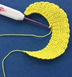 a crocheted banana with a needle hooked up to it