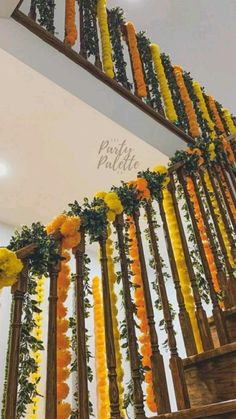 the staircase is decorated with yellow and orange flowers