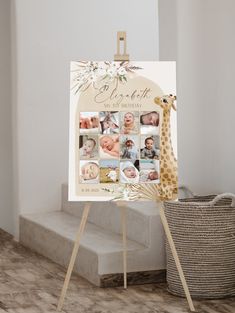 a baby's birth announcement is displayed on a easel next to a basket