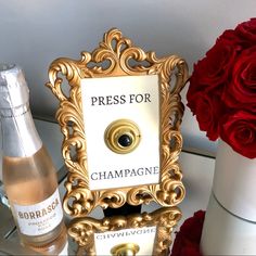 two bottles of champagne and a bottle of champagne are sitting on a table with roses