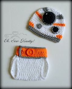 two crocheted hats and diaper covers on a white surface with orange trim