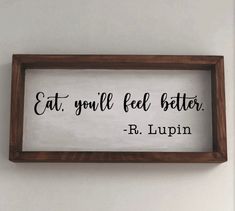 a sign that says eat, you'll feel better r lupin on the wall