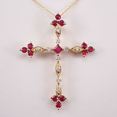 14K Yellow Gold Ruby and Diamond Cross Pendant Necklace Chain. This pendant is set with one genuine Princess Cut Ruby, twelve Round Rubies and ten natural Round Brilliant Diamonds.  The diamonds in this cross are H color, SI clarity and weigh a total of .17 carat. The Rubies are a beautiful red color and amount to a total weight of .61 carats.  This cross measures 34 X 26 mm and comes with an 18" 14K Yellow Gold chain. The pendant and the chain weigh a total of 2.8 grams. This necklace will be a Diamond Cross Necklace, Diamond Cross Pendants, Diamond Cross, Yellow Gold Chain, Unique Gemstones, Cross Pendant Necklace, Fine Jewelry Gift, Fine Jewellery Necklace, Brilliant Diamond