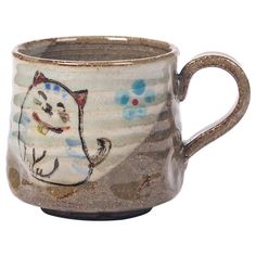 a ceramic mug with a cat on it