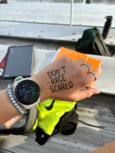 a person with a watch on their wrist that says, don't race scared