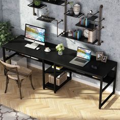 a computer desk with two laptops and shelves on the wall above it, along with a chair