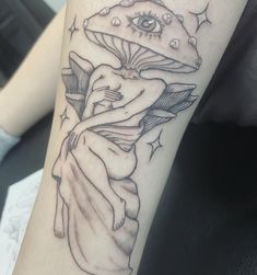 a black and white photo of a woman's arm with a mushroom on it