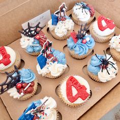 cupcakes decorated with red, white and blue frosting are in a box