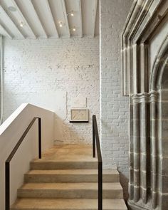 there is a white brick wall and some stairs