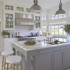 a large kitchen with an island in the middle